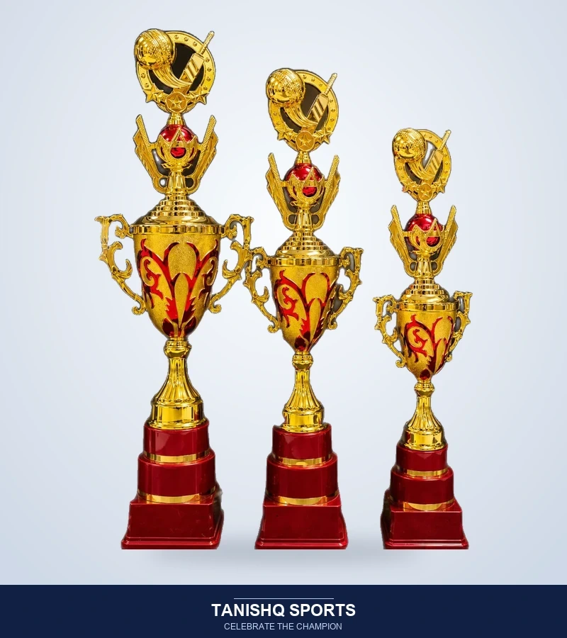 Three golden cricket champion trophies with ruby red bases